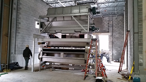 Custom-Designed Screw Feeder with Hopper to Distribute Dewatered Biosolids to Belt Dryer for Pottstown, PA - KWS