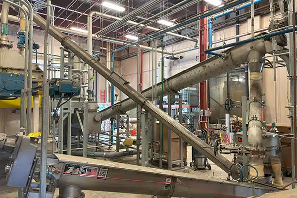 Two KWS Inclined Screw Conveyors Receive Dried Biosolids from Screener