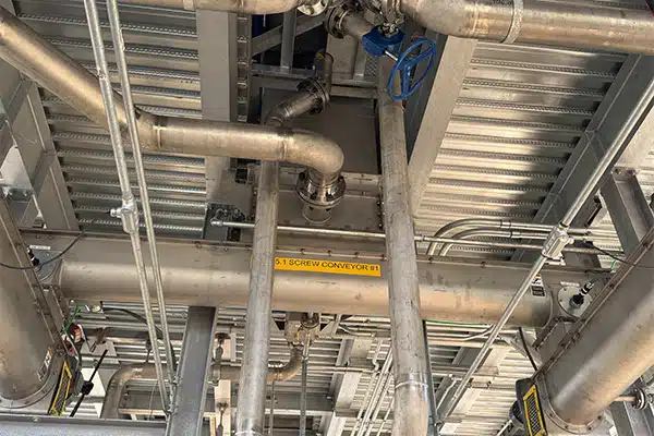 Centrifuge Discharges Sludge to Reversing Shaftless Screw Conveyor