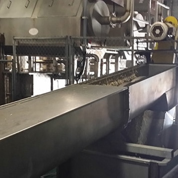 Inclined Screw Conveyors & Truck Load-Out Conveyors to Convey Offal Meat & Feathers at a Mountaire Farms Chicken Processing Plant - KWS Manufacturing