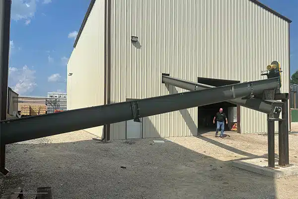 Sawdust is Conveyed by Transfer Screw Conveyors to Be Used as Fuel for Kiln