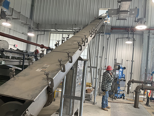 Inclined Screw Conveyor Conveys and Elevates Biosolids to Load Out Area