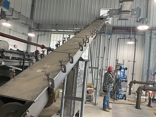 Inclined Screw Conveyor Conveys and Elevates Biosolids to Load Out Area