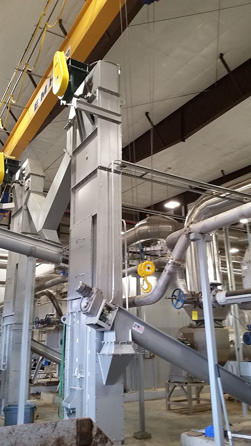 Bucket Elevators Elevate Dried Biosolids to Load Out Screw Conveyors