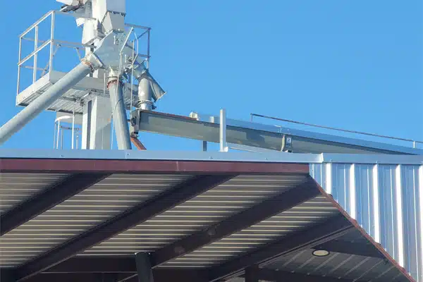 Feed is Transferred from Storage to a Bucket Elevator and then to a Transfer Screw Conveyor and Truck Load Out