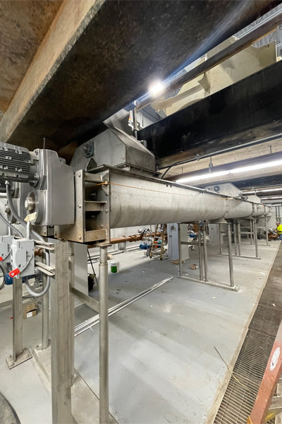 Transfer Screw Conveyors Receive Dewatered Biosolids from Centrifuges